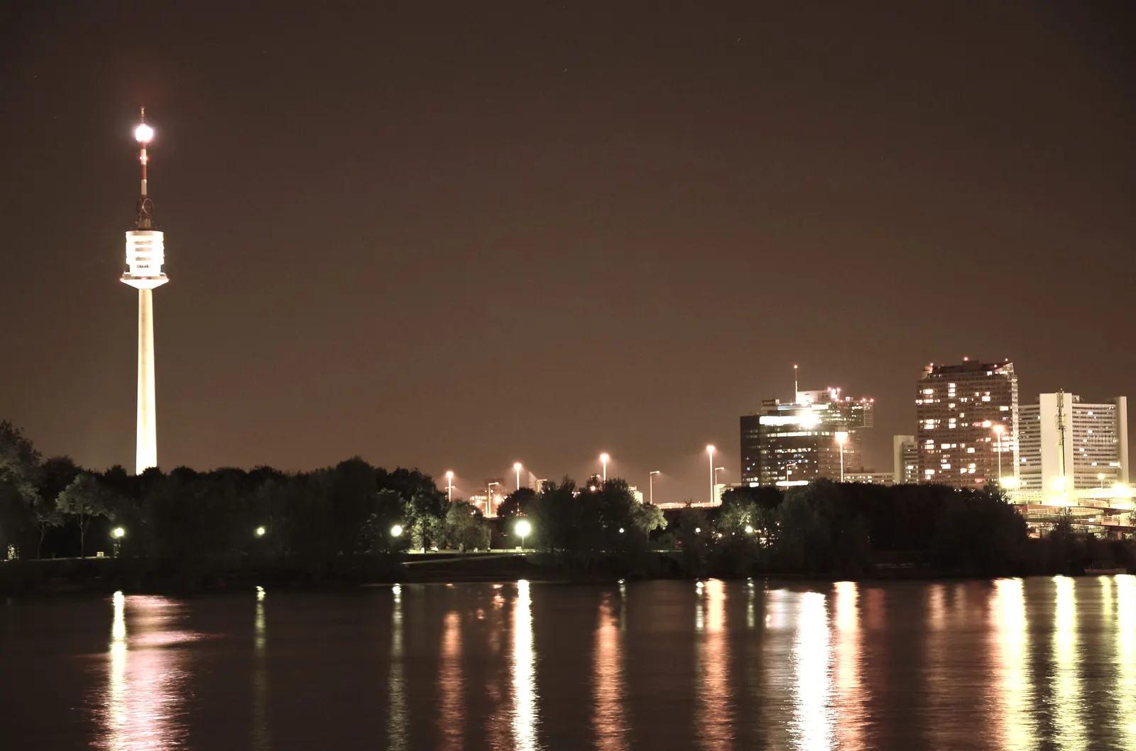 Vienna at night, the Danube Tower seen across the Danube