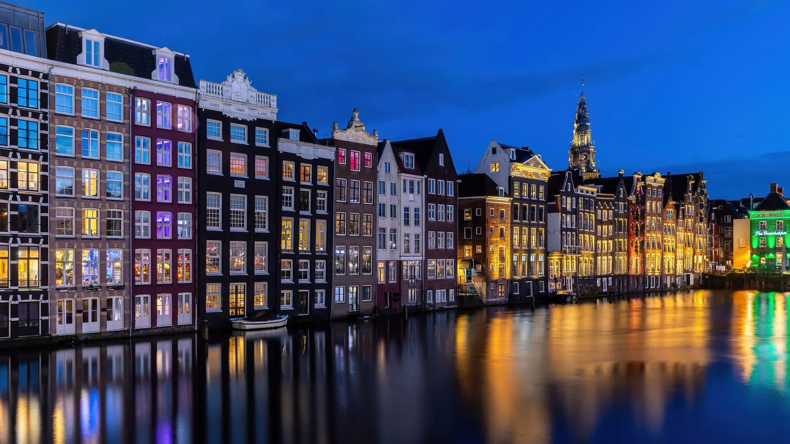 Canal houses on the Damrak in Amsterdam at blue hour